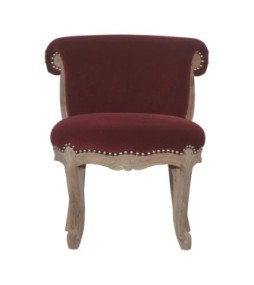 Fauteuil clouté en velours rouge bordeaux